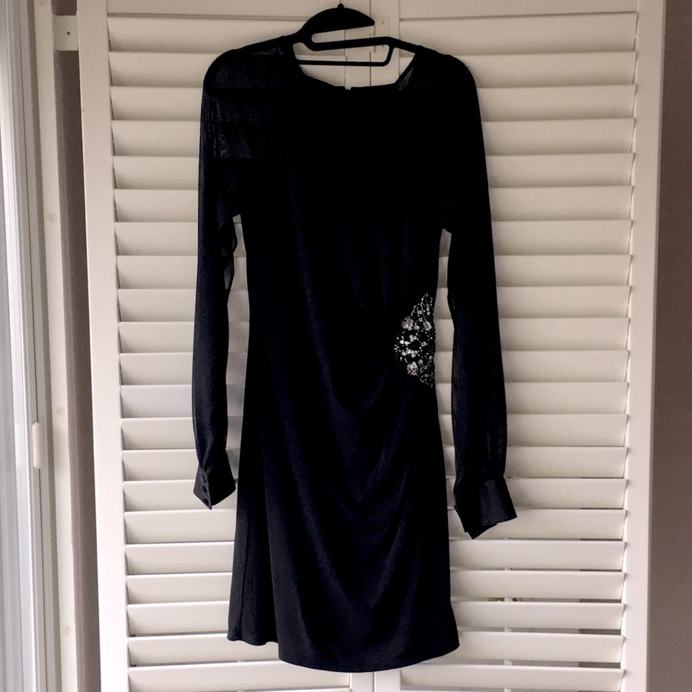 Black chic party dress with sheer sleeves and jeweled detail for elevated look